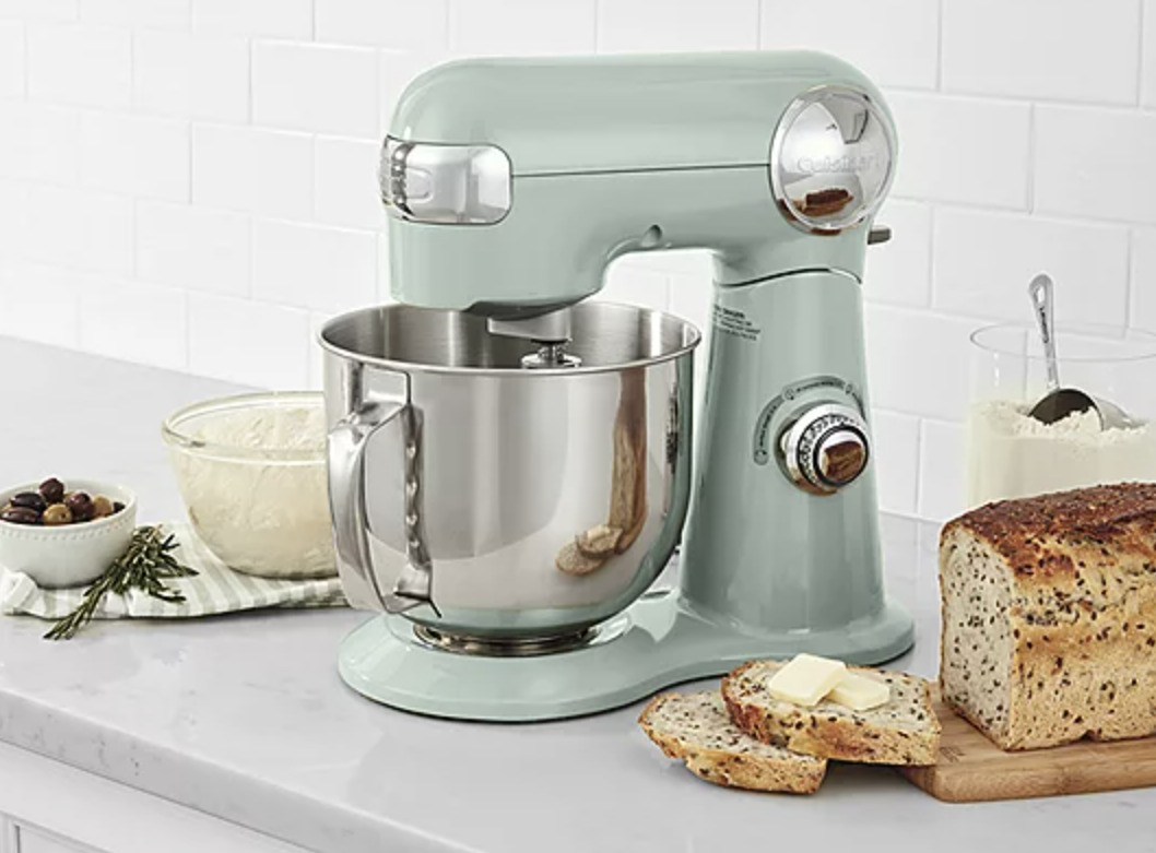 mint Cuisinart stand mixer on table next to fresh loaf of bread and olives in dish
