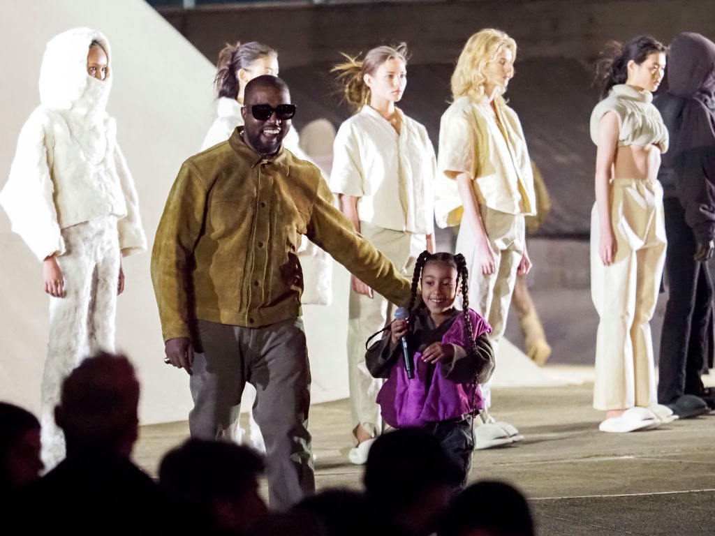 Ye on the runway with models wearing his fashions