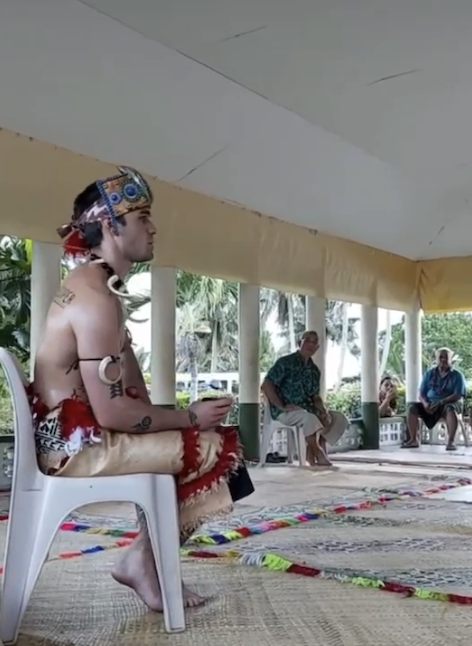 KJ sitting on a chair during the ceremony