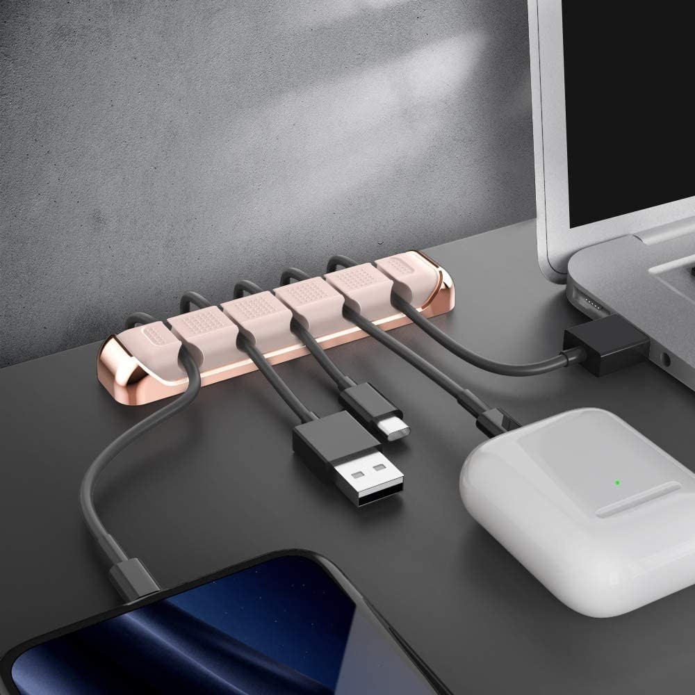 The cable holder on a desk with wires in each slot