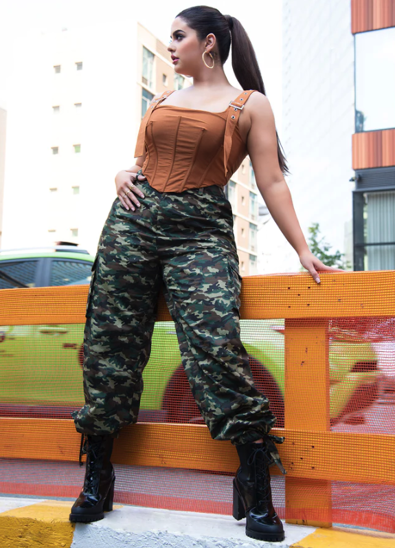 model wearing the camouflage pants with a brown corset top