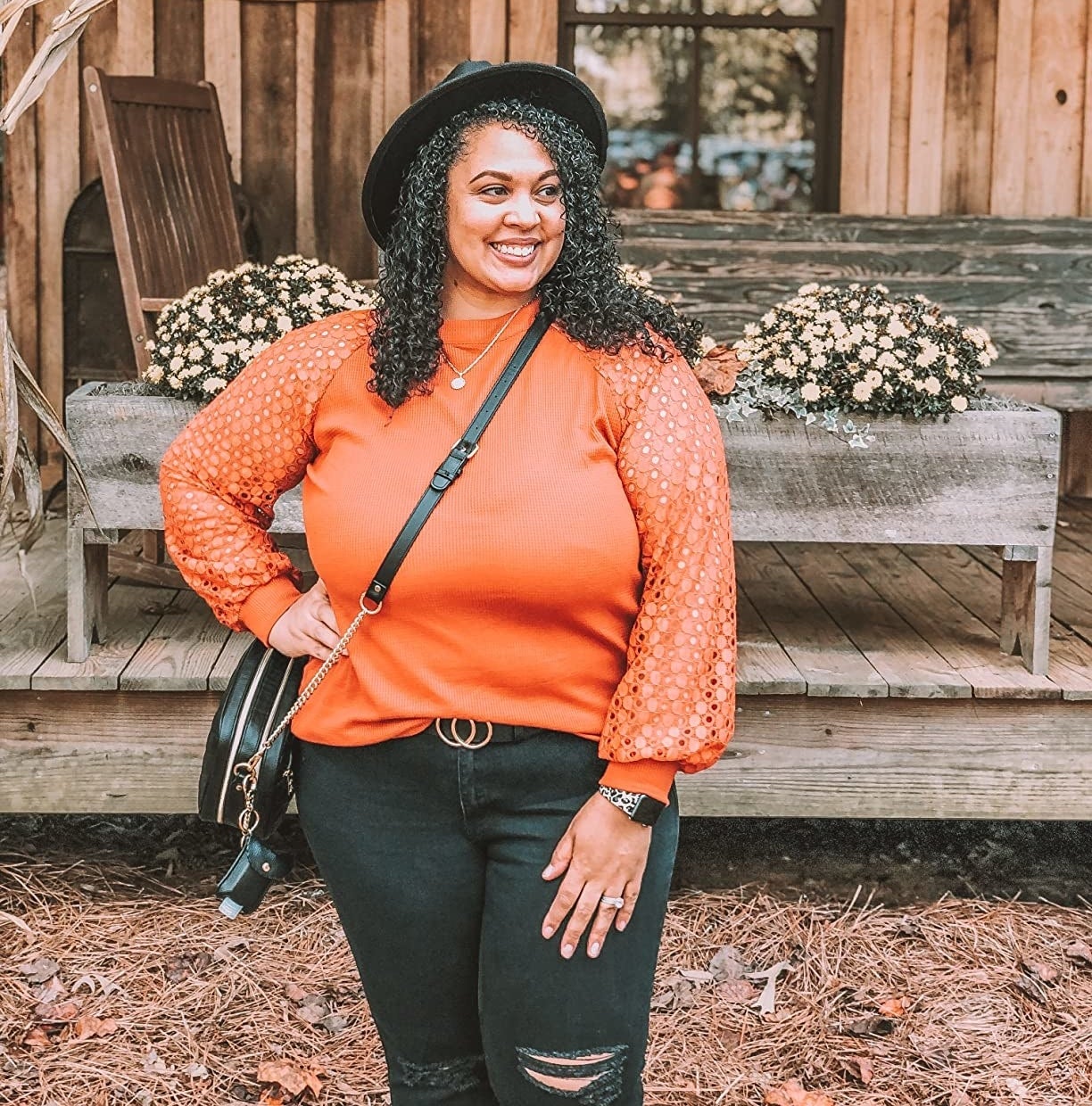 a reviewer wearing the top in orange