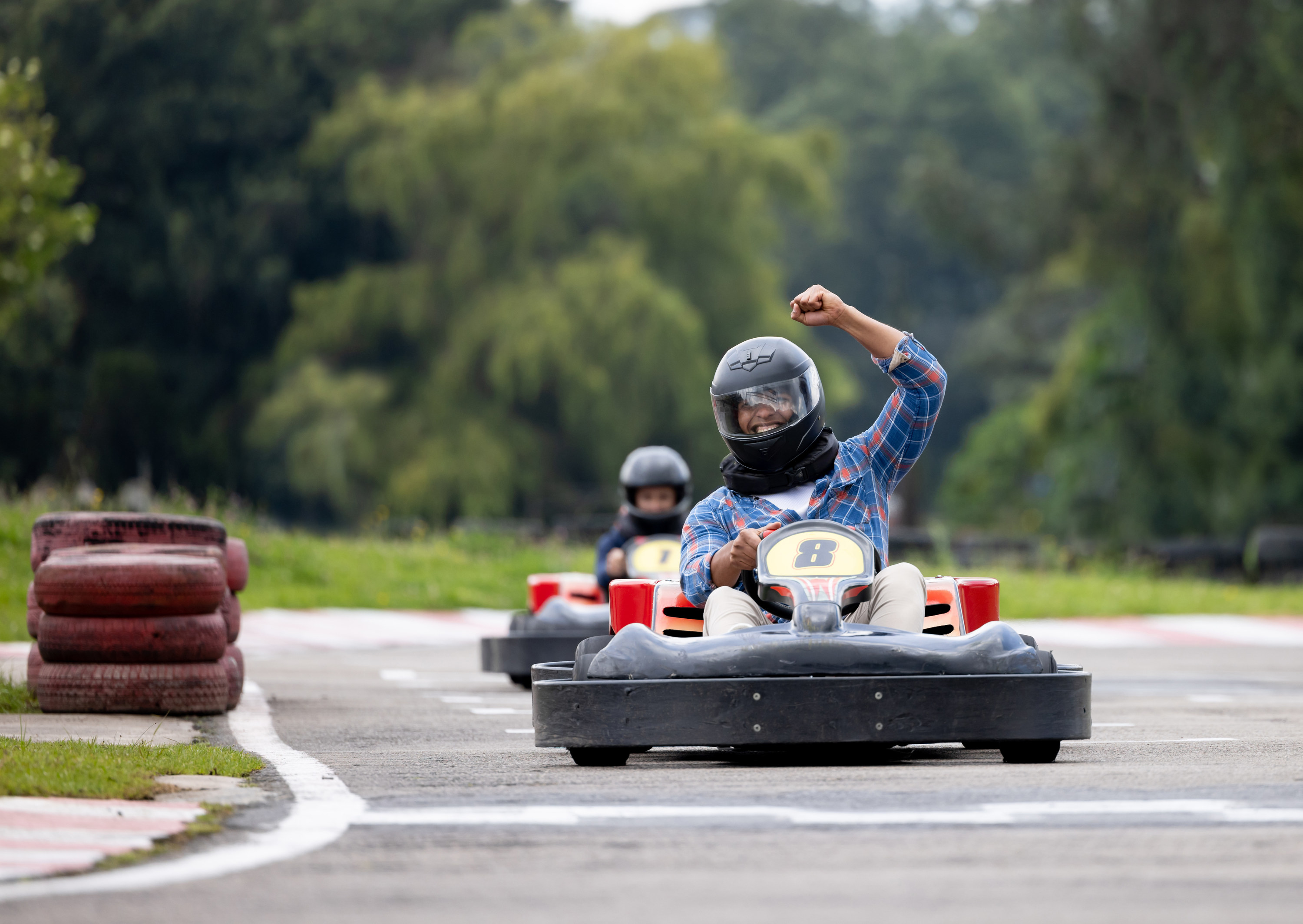 people racing go karts