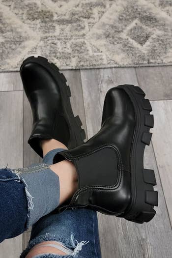 a reviewer wearing black boots