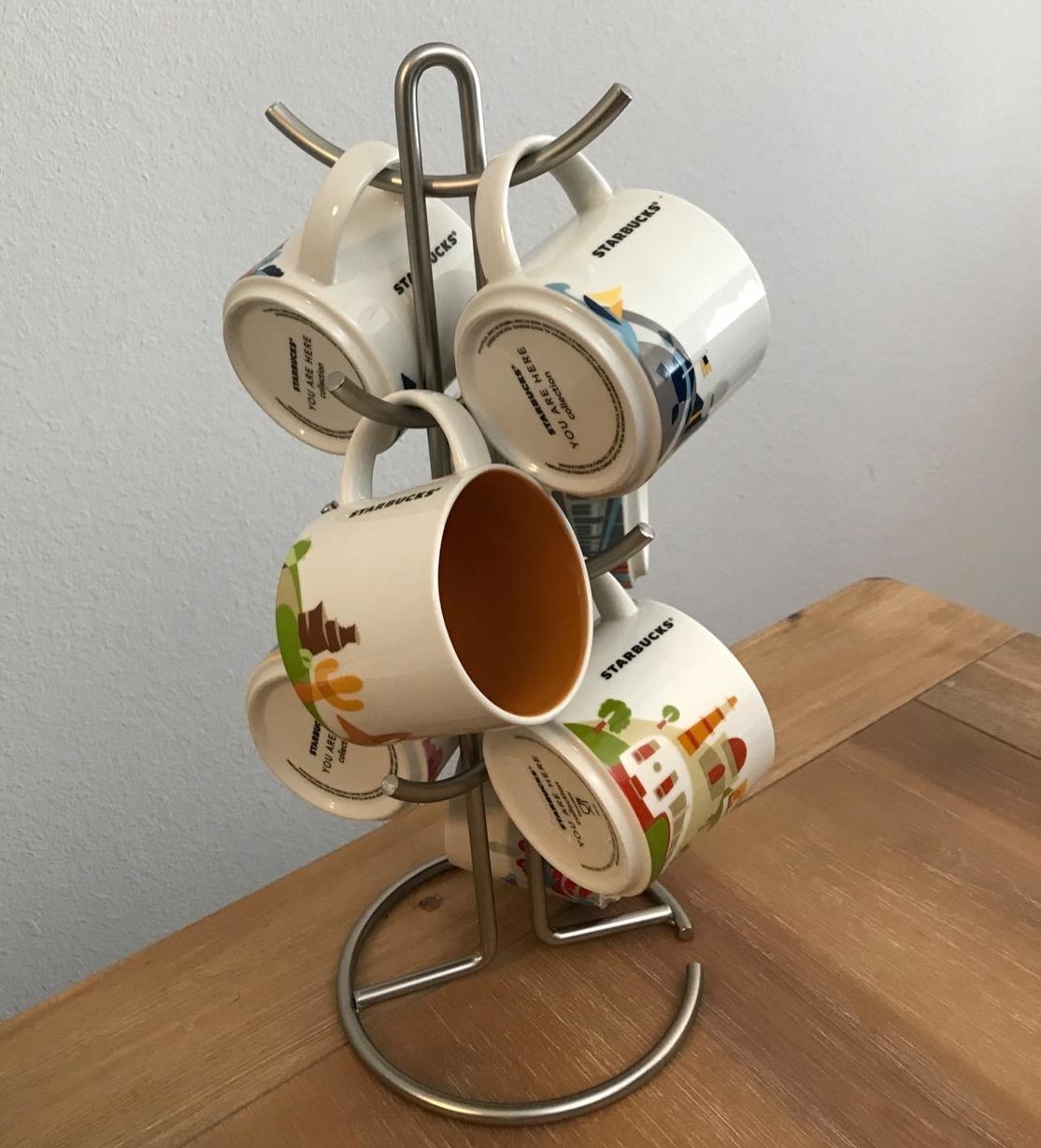 a reviewer photo of the mug tree with mugs hanging on it