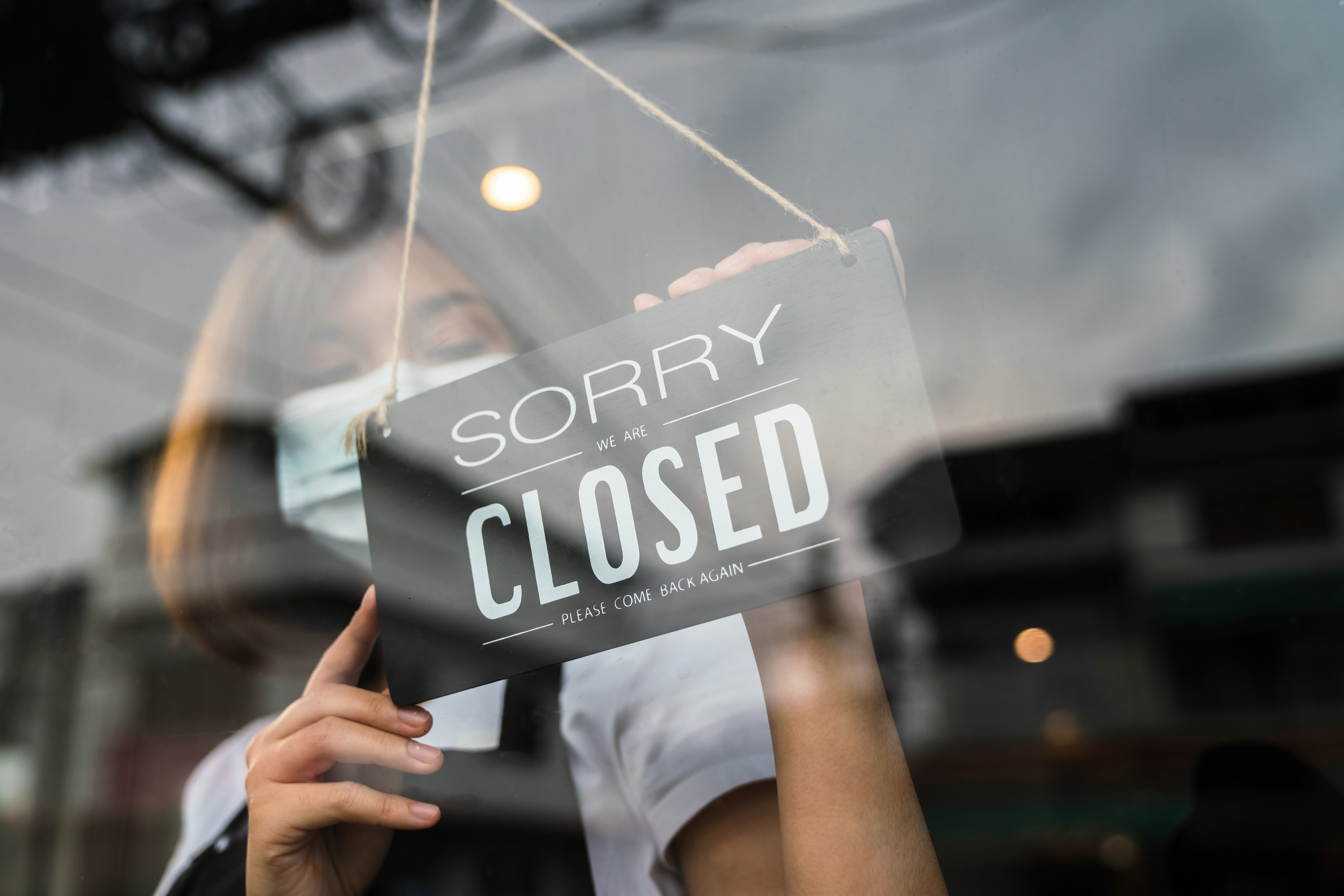 window sign that says sorry we are closed