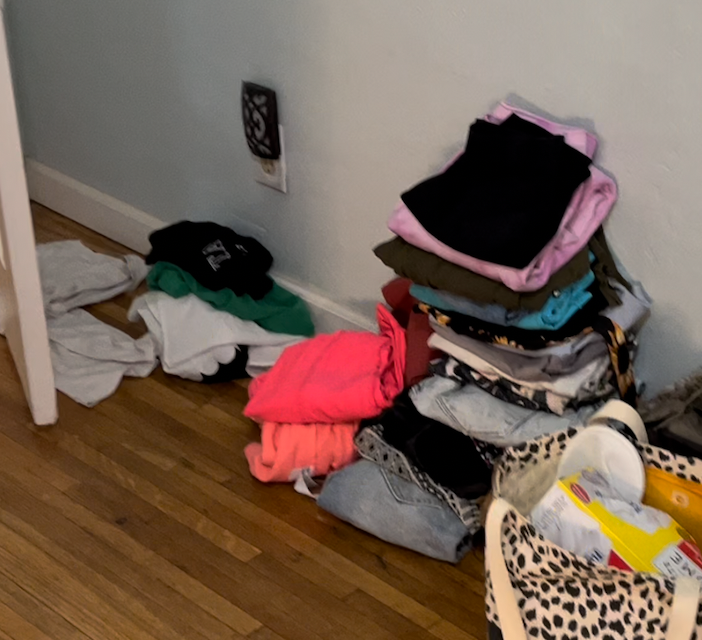 Piles of folded clothes on the floor