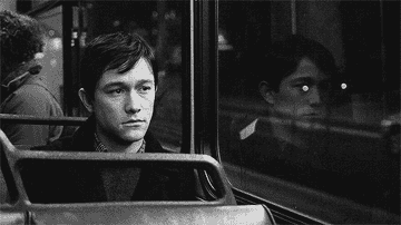 Joseph Gordon Levitt alone on the bus looking sad