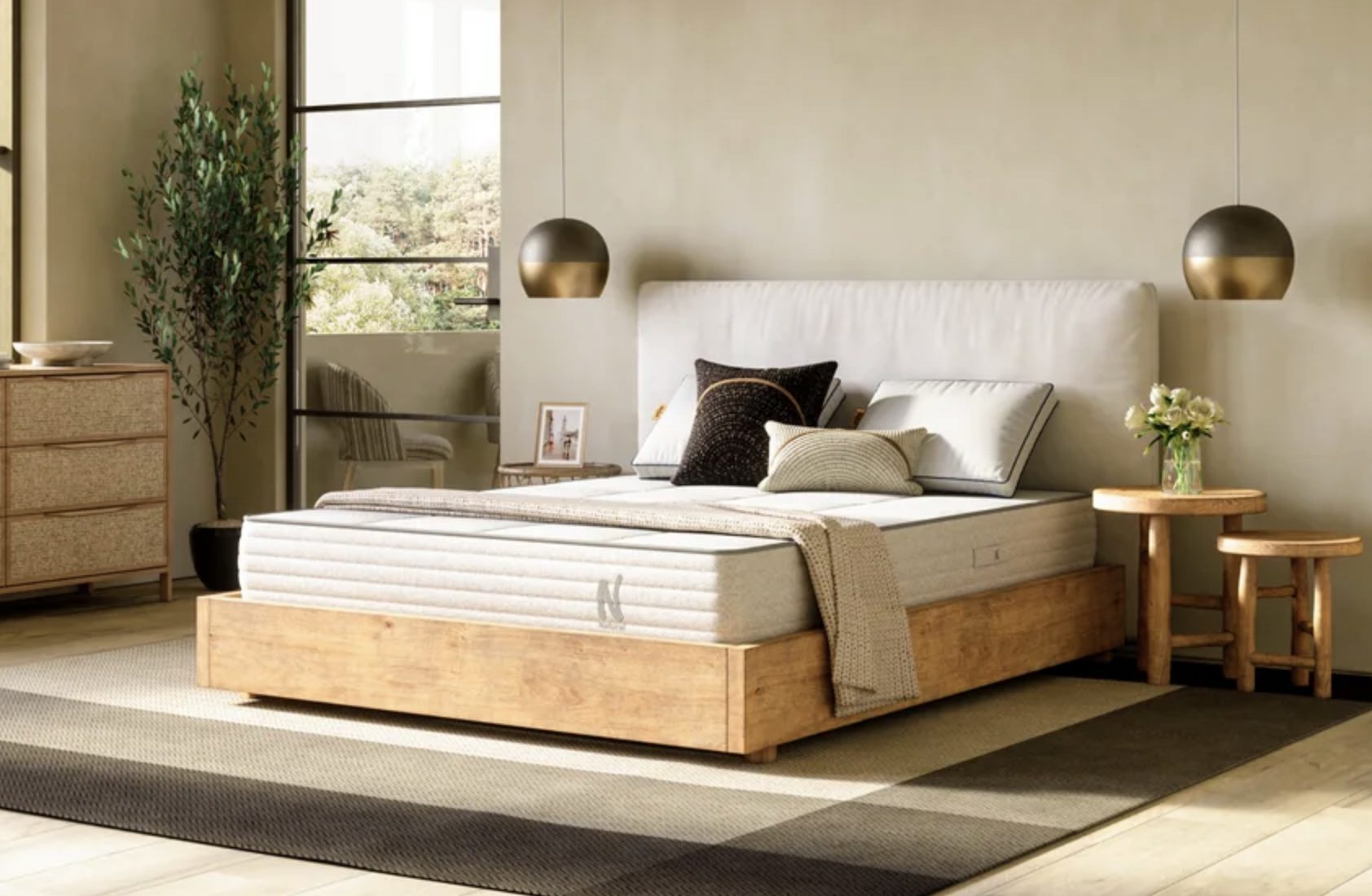 A bare mattress is shown on a bed in a bedroom