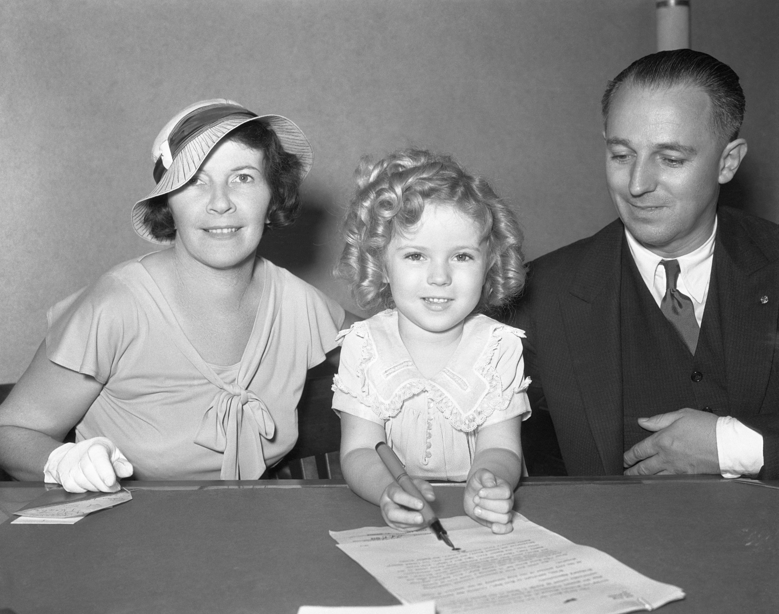 Shirley Temple signs a contract with her parents