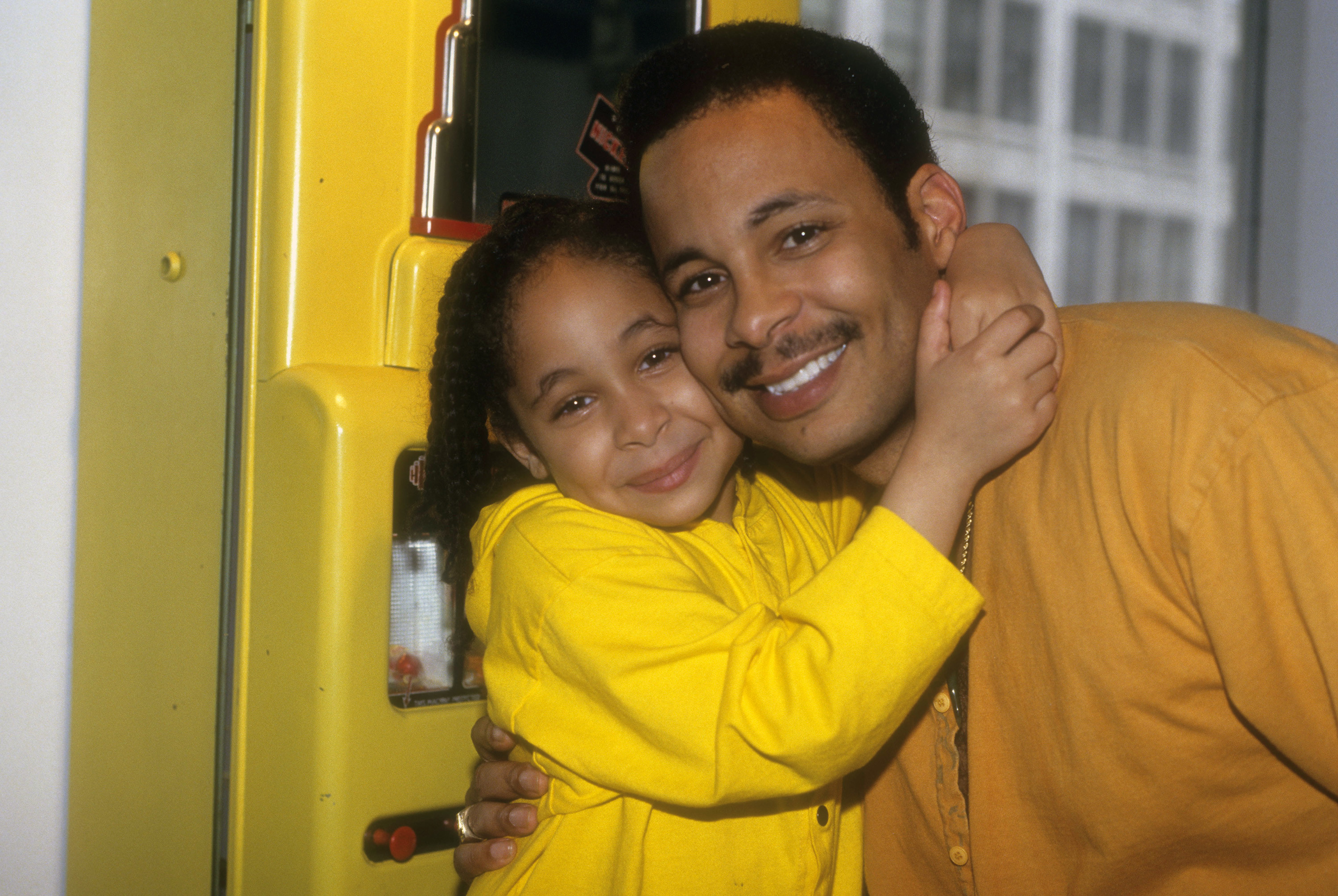 Seven-year-old Raven-Symoné gives her father a hug