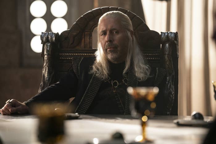 Viserys sits at the Small Council table