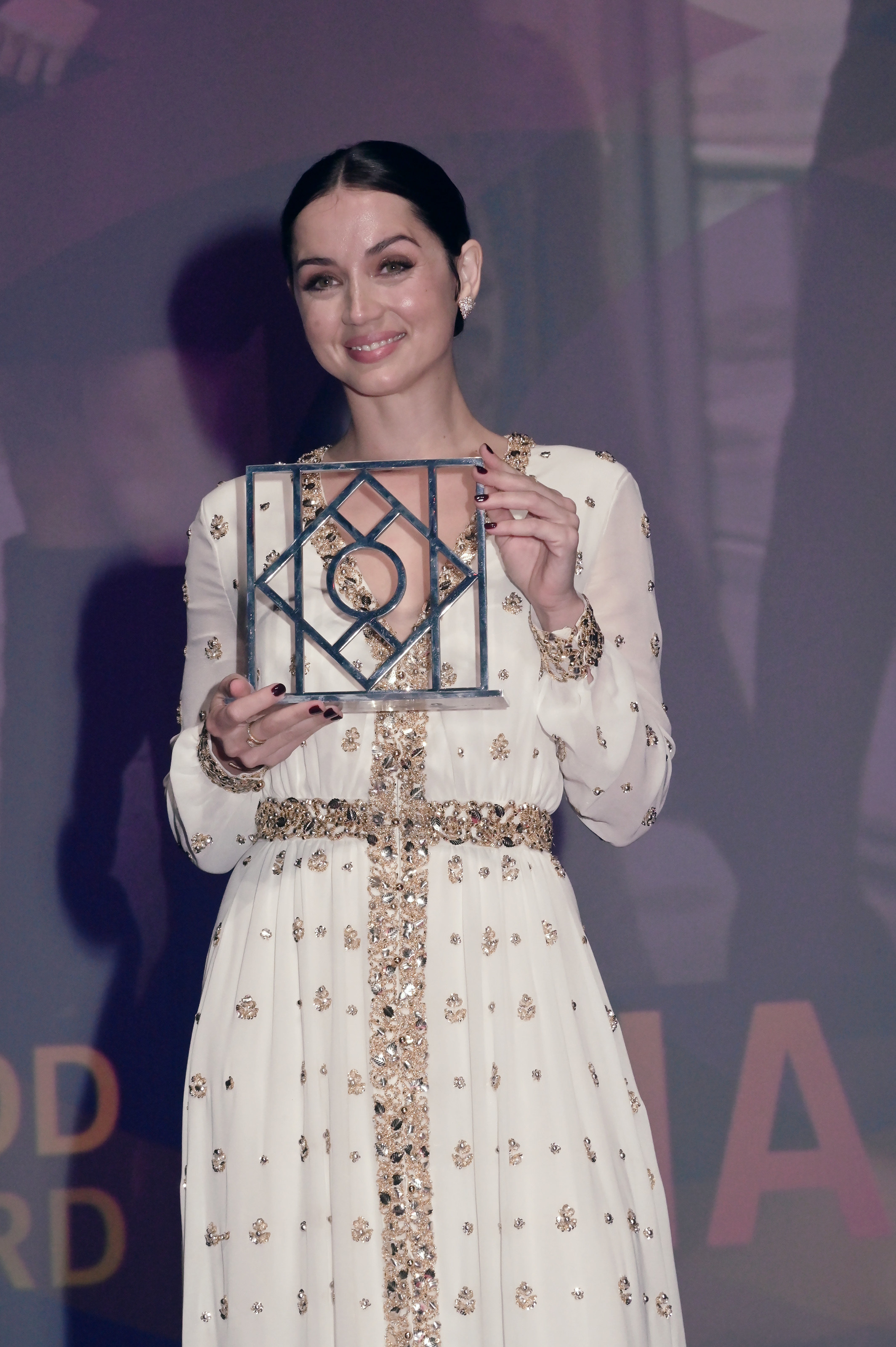 ana holding an award