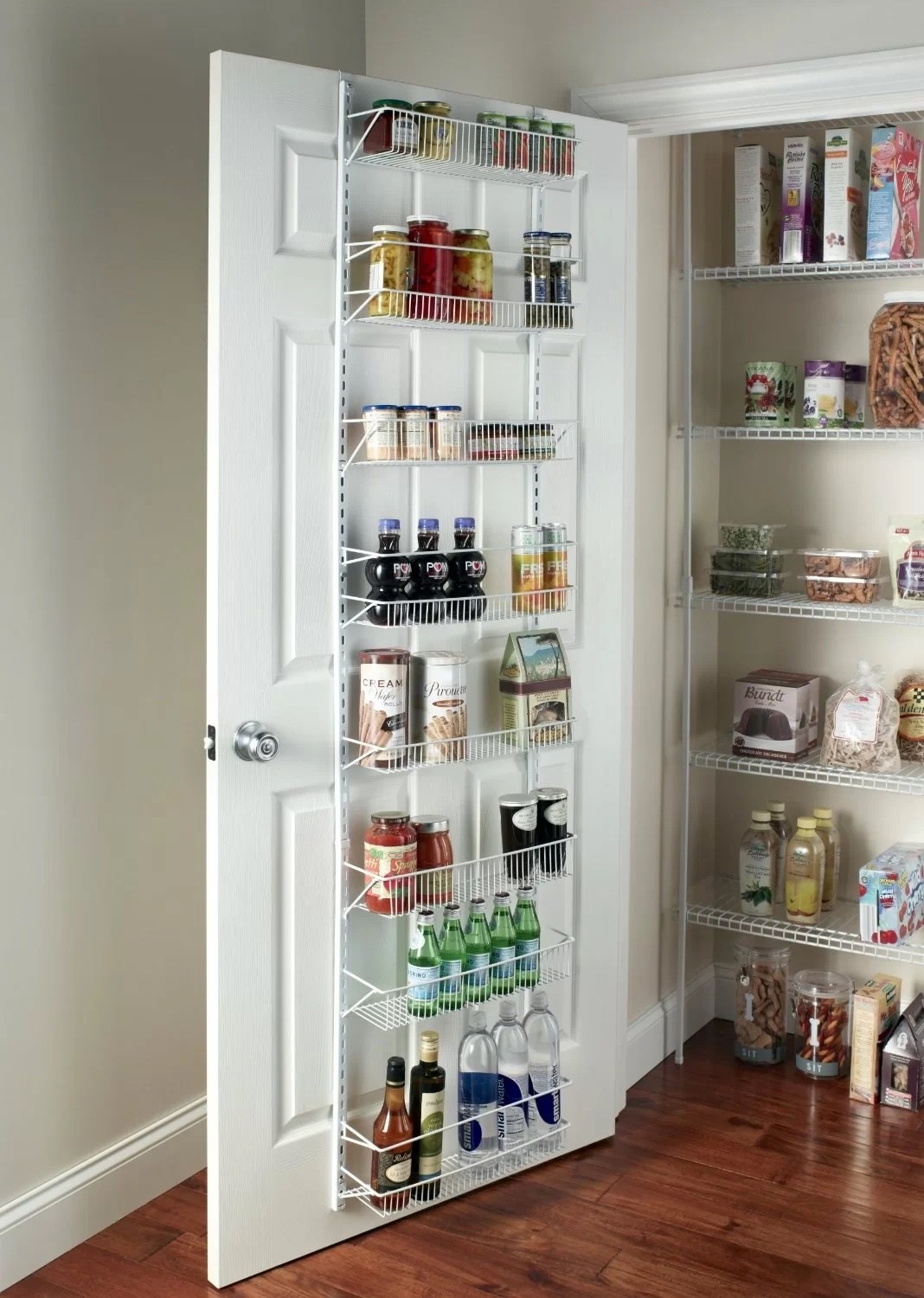 a white cabinet door organizer holding bottles, snacks, and jars