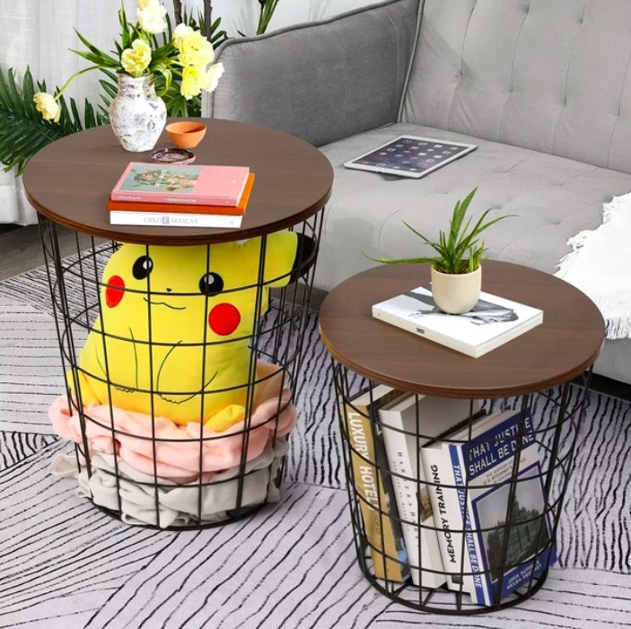 Two end tables with books, toys and blankets inside them