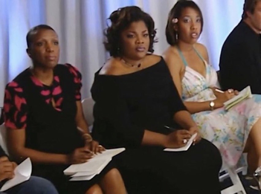 Women sitting with notebooks and pens and disapproving looks