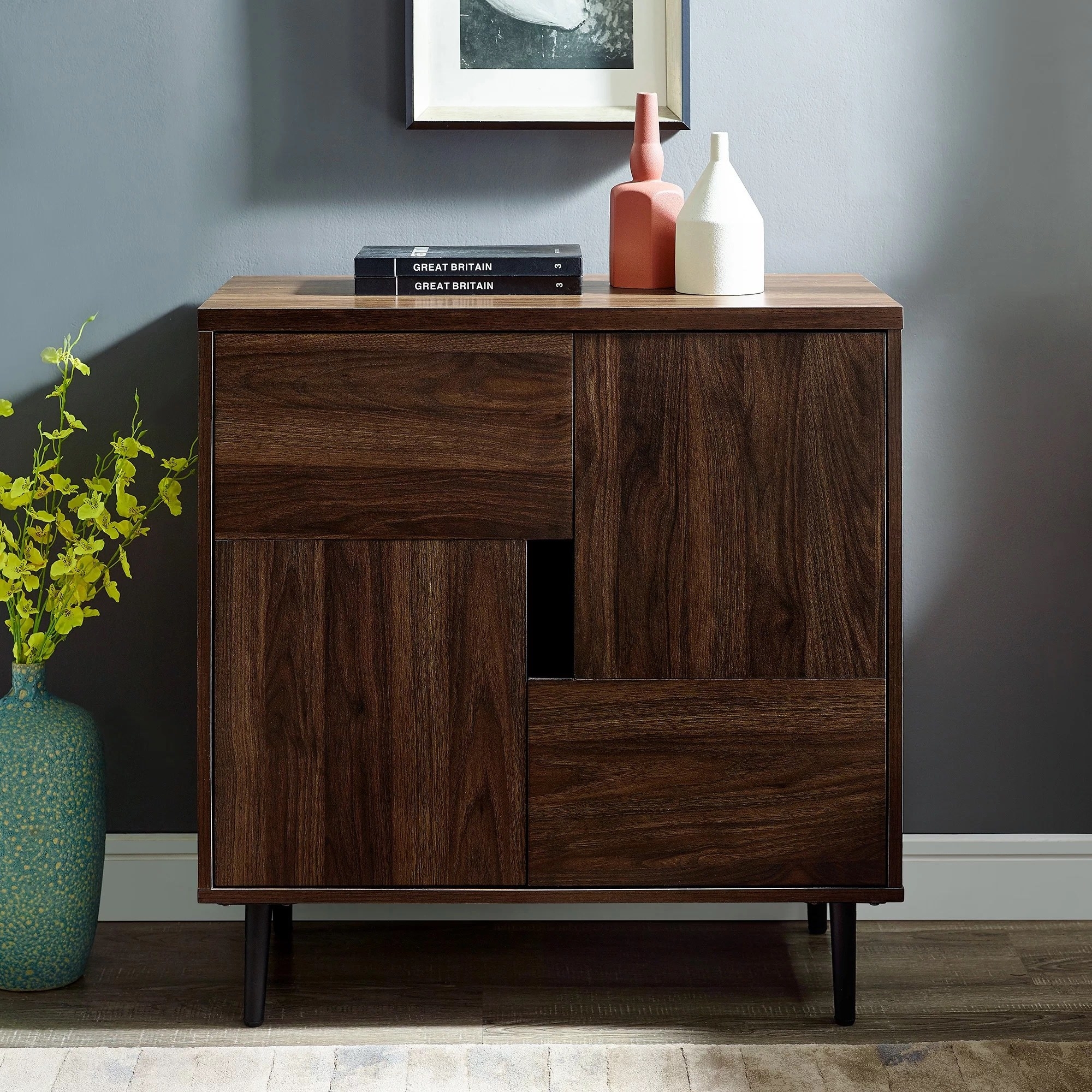 a square accent cabinet in dark walnut in a living room with books and vases on top