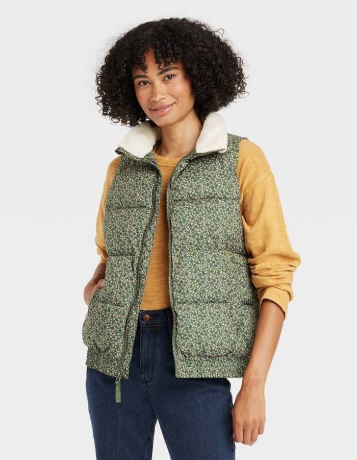 model wearing green floral puffy vest