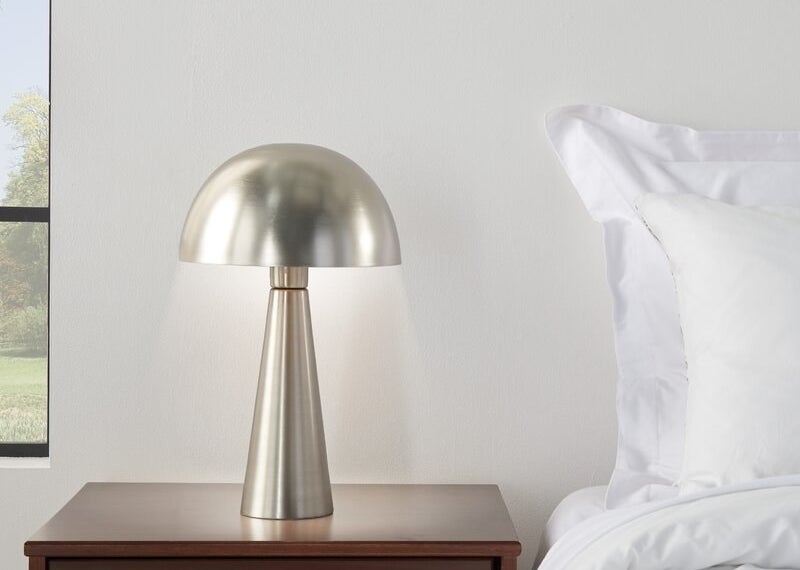 the silver lamp on a nightstand