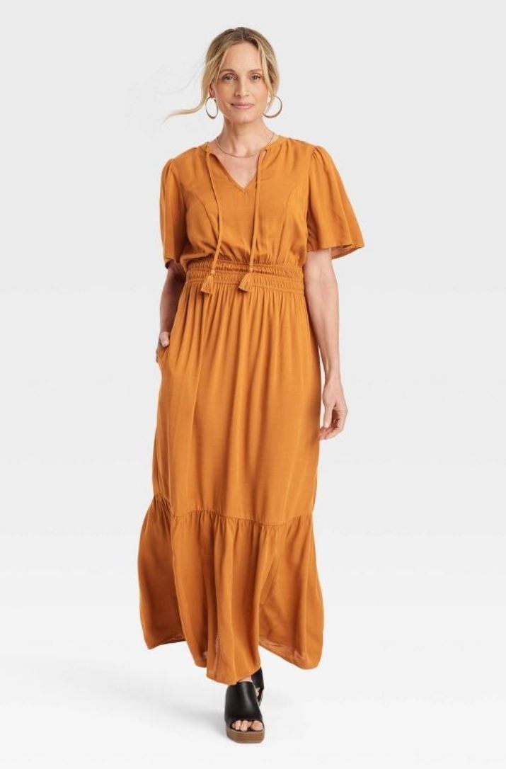 model wearing long a-line rust dress