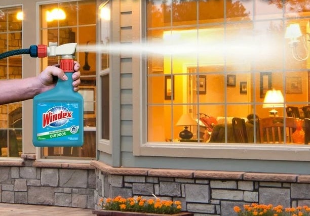 Cleaner being sprayed on windows