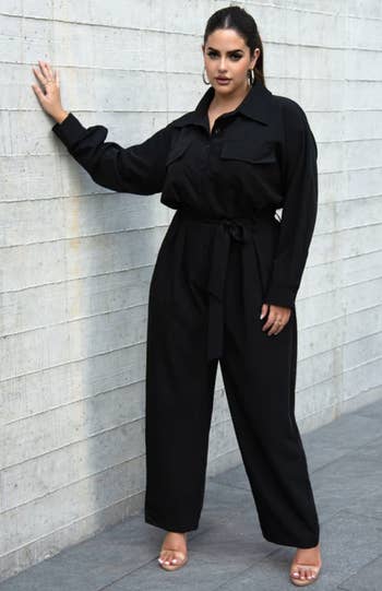 front view of a model in the black long sleeve jumpsuit