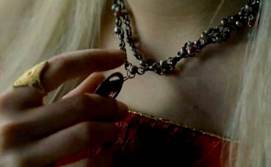 Rhaenyra plays with the necklace Daemon gave her