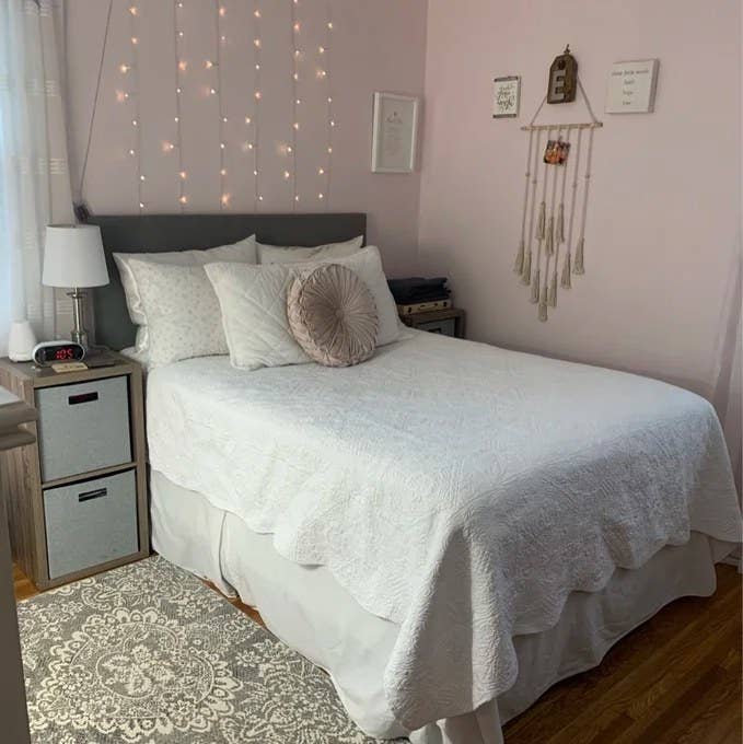 A reviewer's image of the gray upholstered headboard