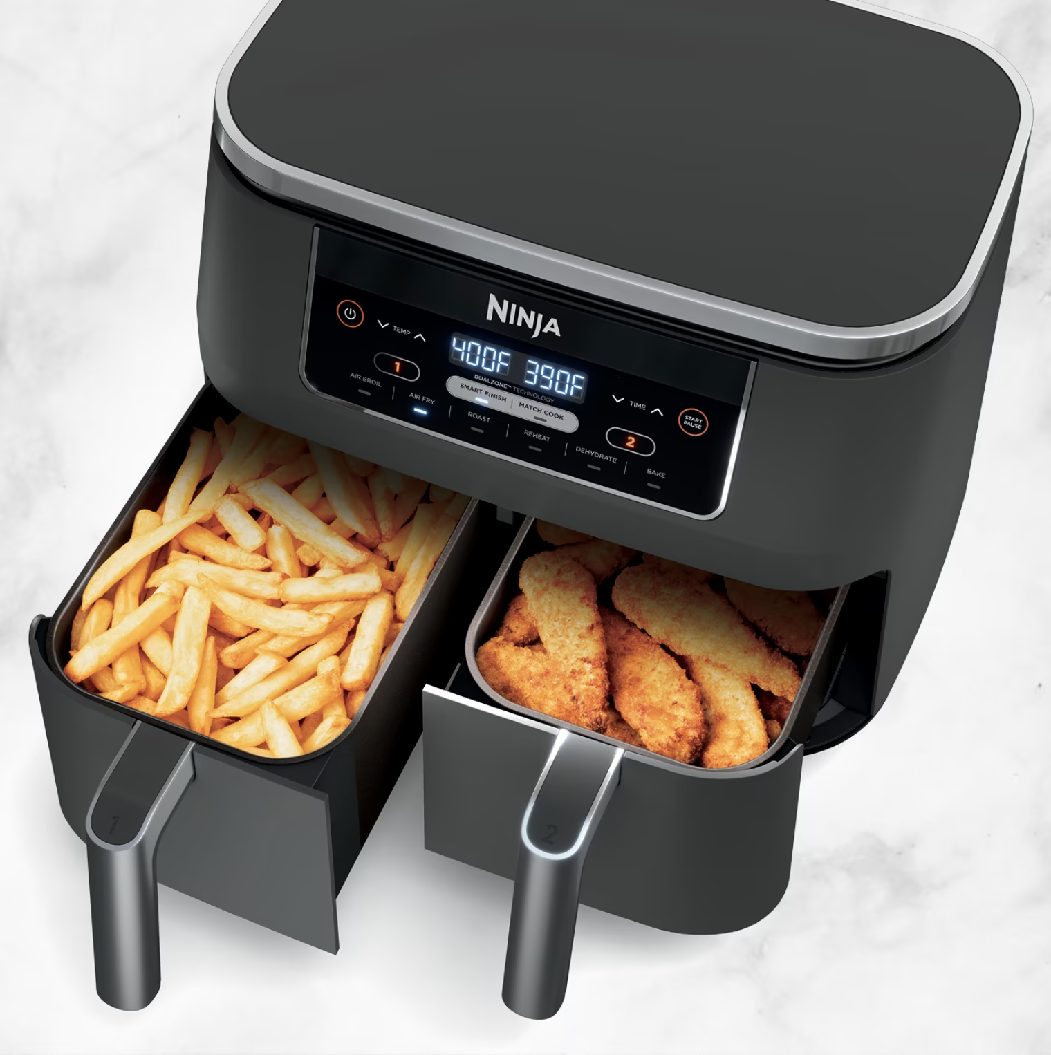 The air fryer baskets filled with fries and chicken tenders