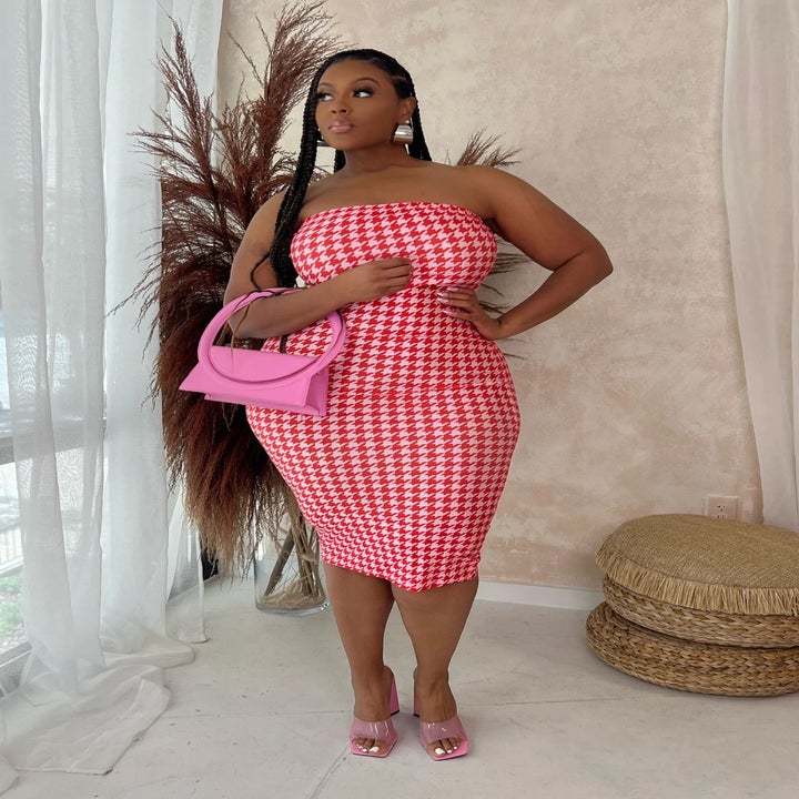 a model wearing a pink checker-printed strapless dress