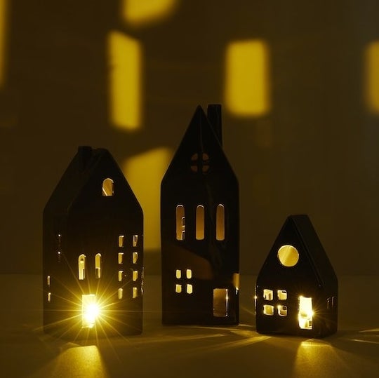 a trio of ceramic mini houses with led lamps inside