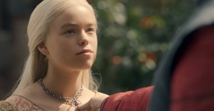 Daemon touching the necklace he gave Rhaenyra as she wears it