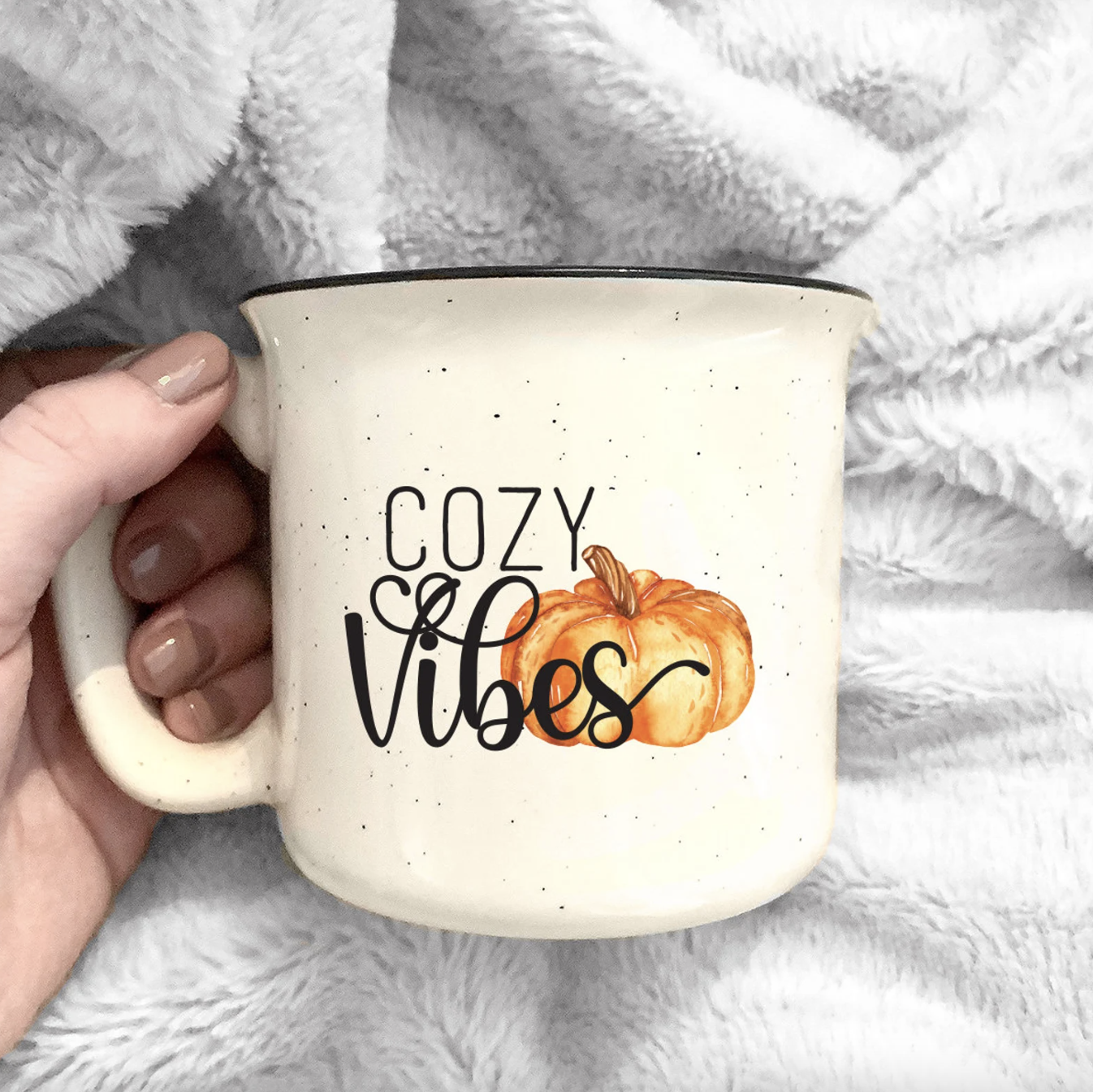 a camp-style mug with the words cozy vibes on the front with a pumpkin graphic