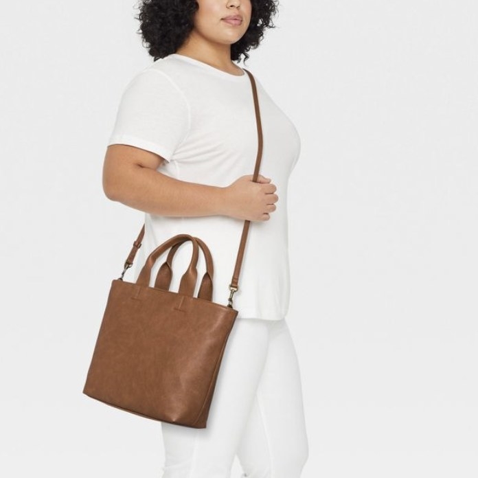 The brown bag has tote straps and a larger crossbody strap