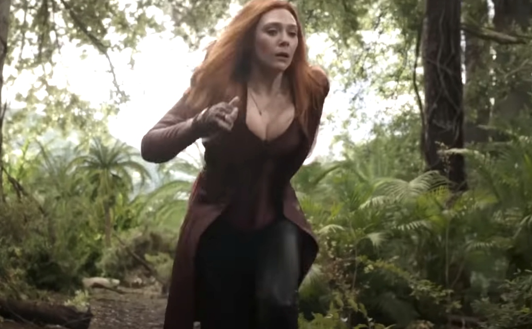 scarlet witch running while her cleavage is showing over her suit