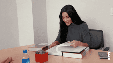kim kardashian flipping through a book