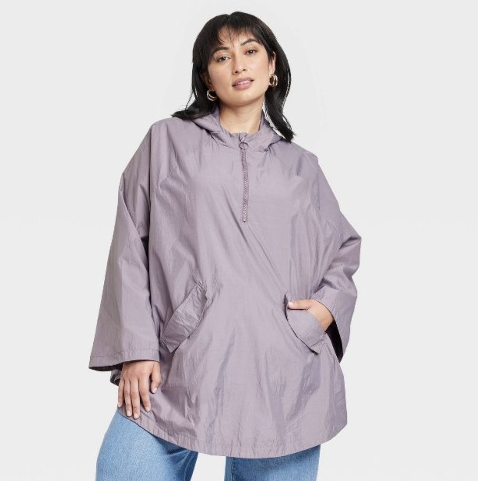 The model wears the light purple raincoat with jeans