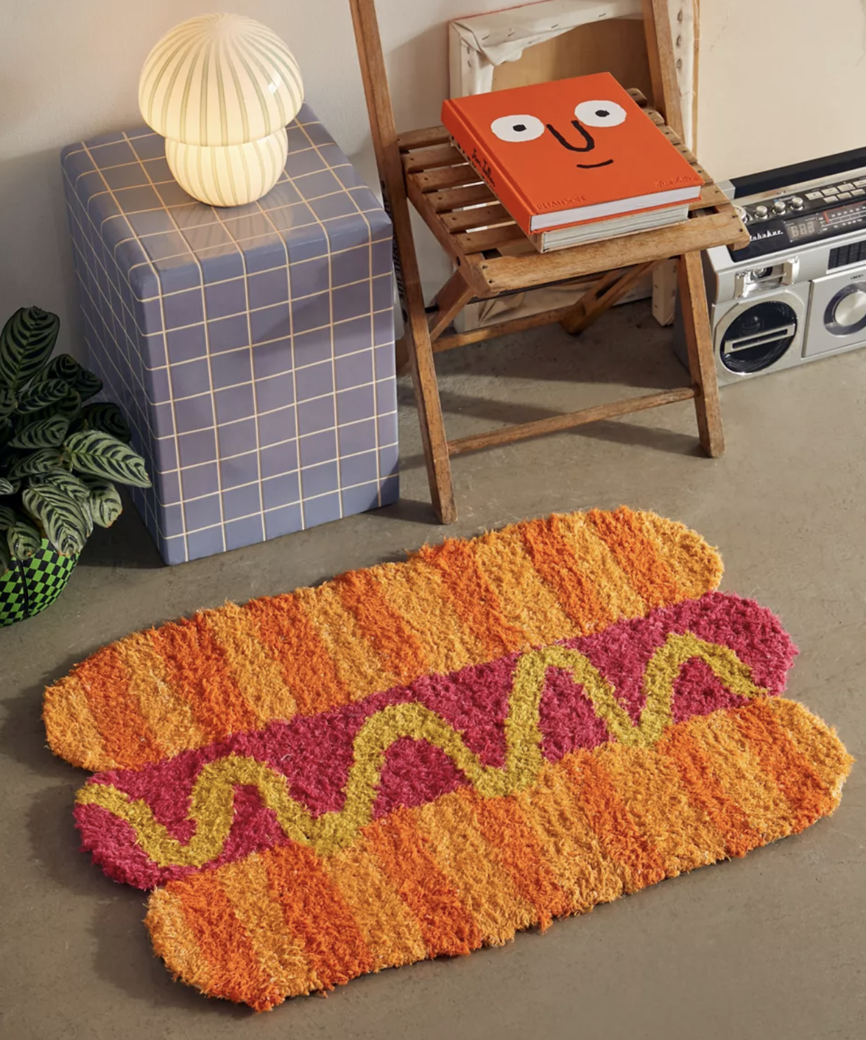 The hot dog rug in front of a chair and table