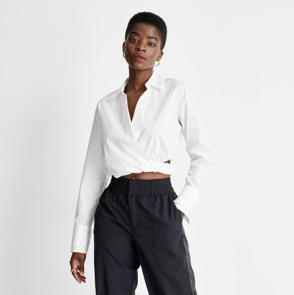 The model is wearing the white top with black pants
