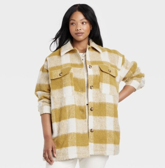 The mustard yellow plaid has brown marbled buttons