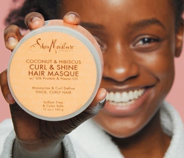 a model holding the hair masque