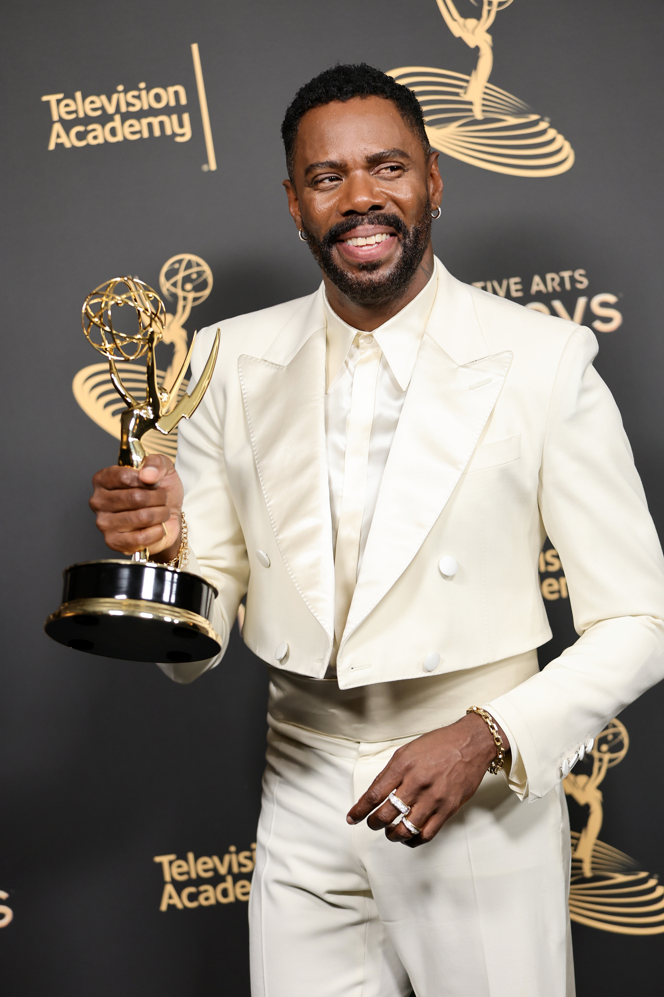 Colman Domingo holding his Emmy and smiling