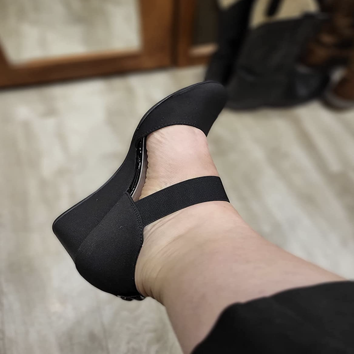 reviewer wearing the wedge pump with elastic strap