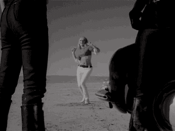 A woman dances in the desert