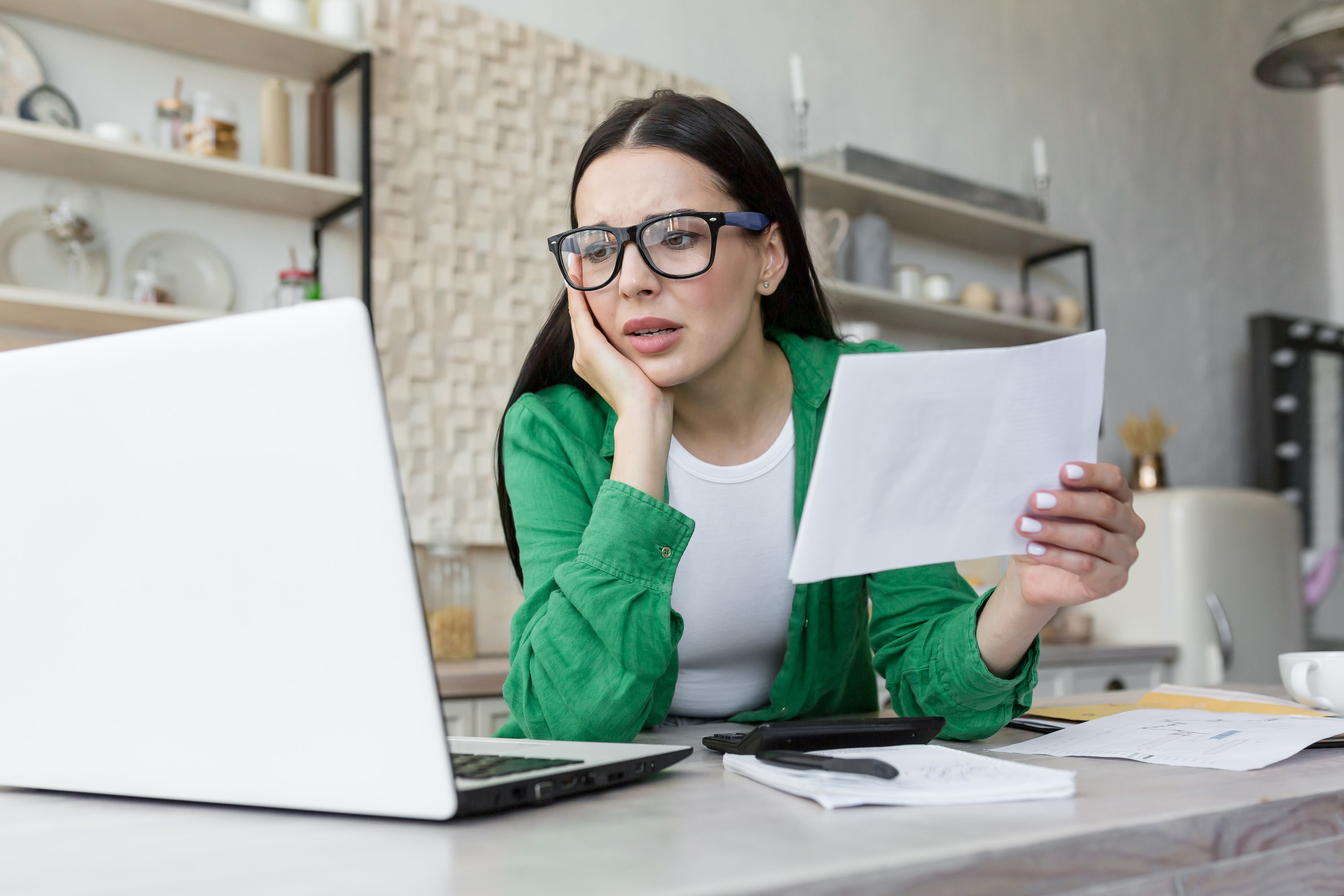 stressed out woman looking at loan paperwork