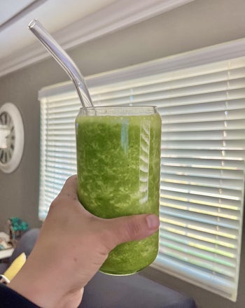 a reviewer's glass with a smoothie inside