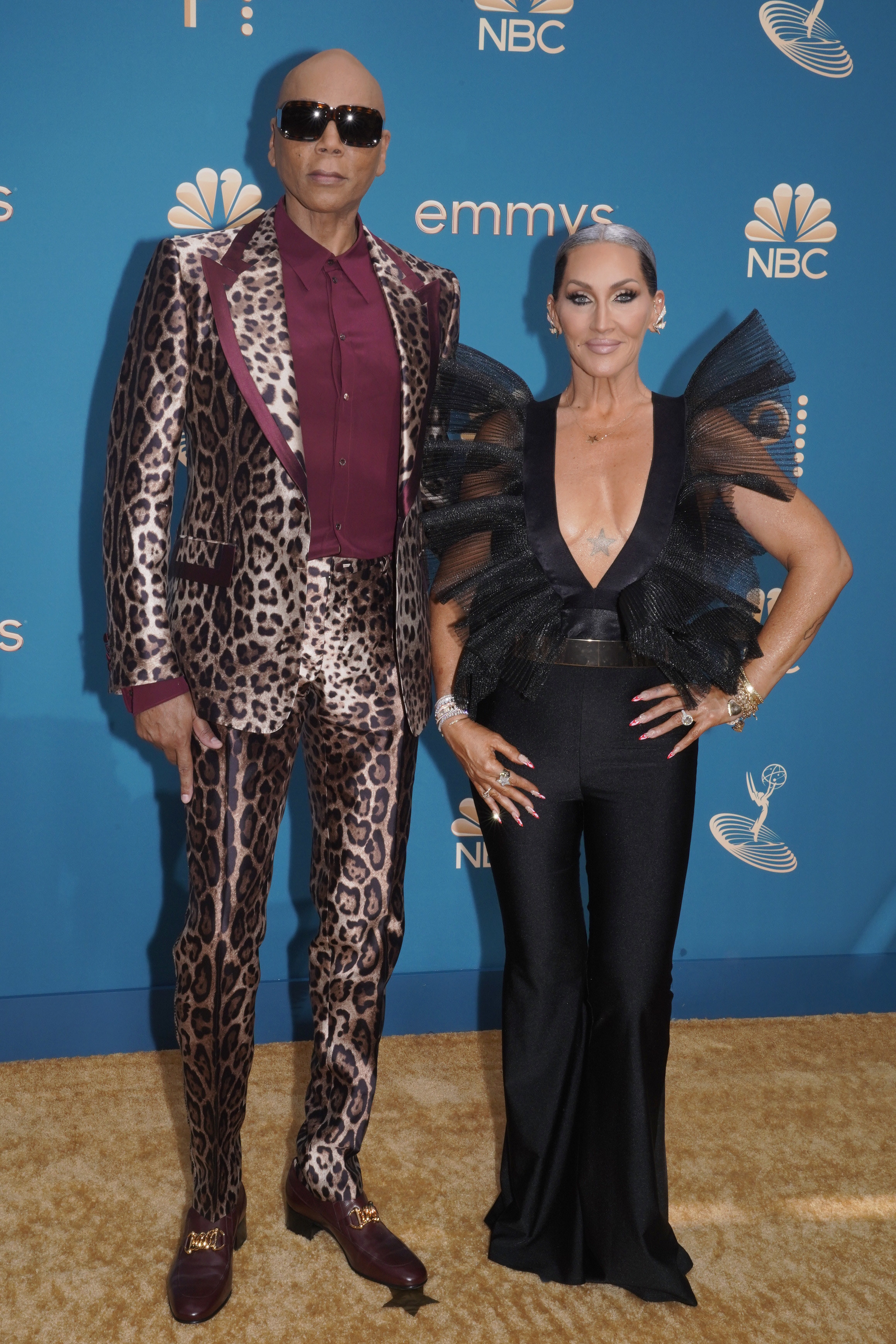 RuPaul wearing a cheetah print suit and Michelle Visage in a black jumpsuit