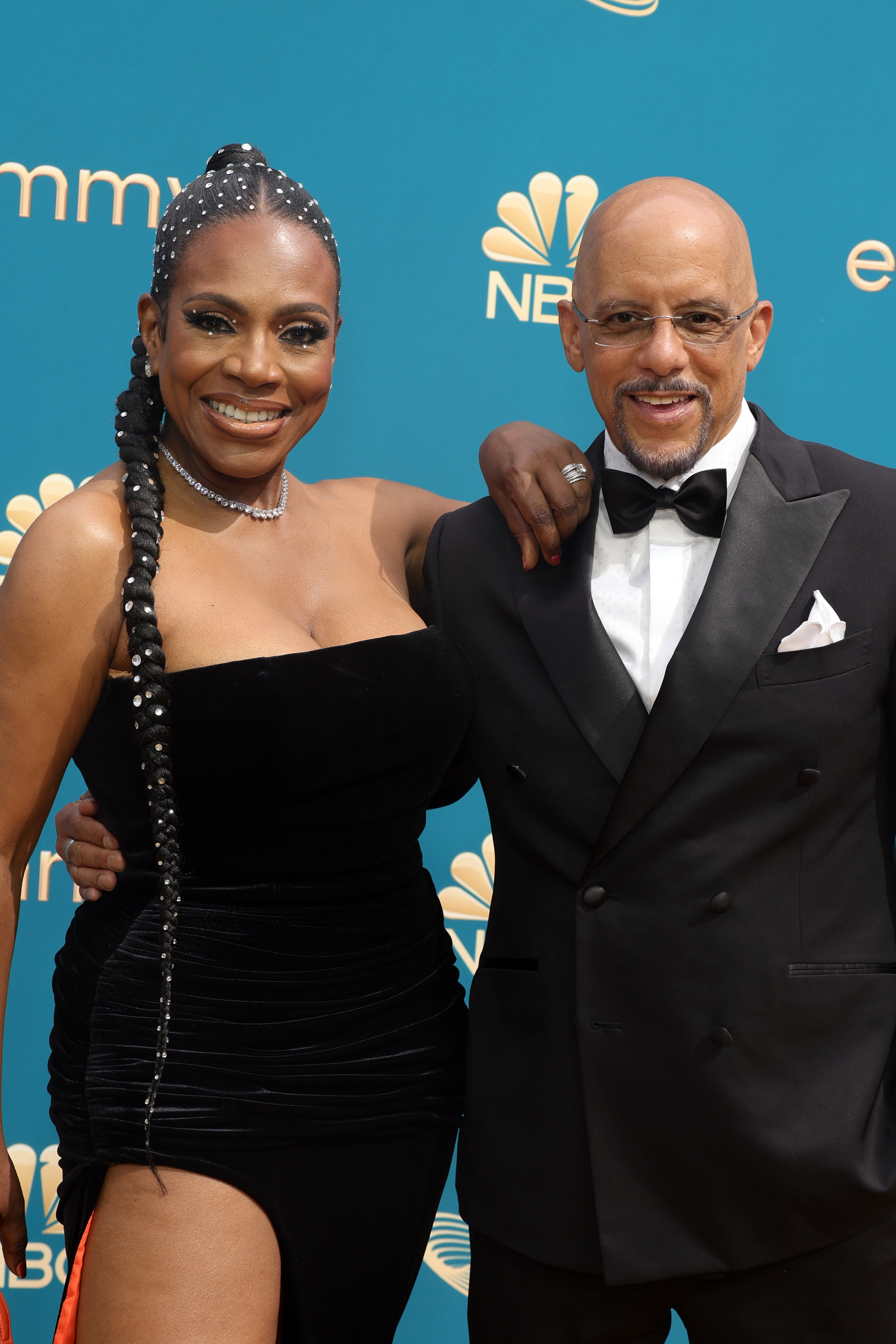 Sheryl Lee Ralph in a black dress with a slit and Vincent J Hughes in a black tux