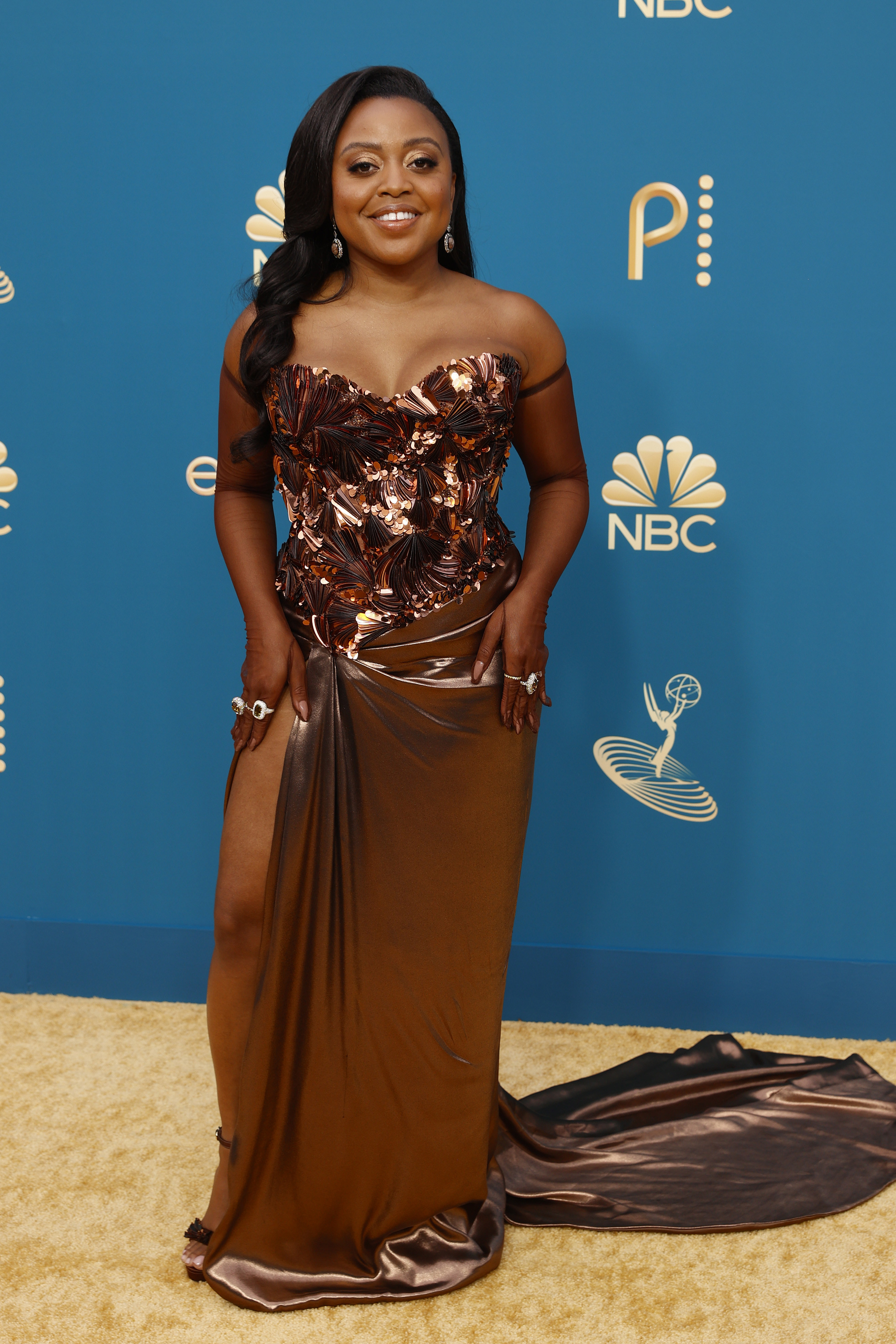 Quinta Brunson in a shimmery brown gown with a slit