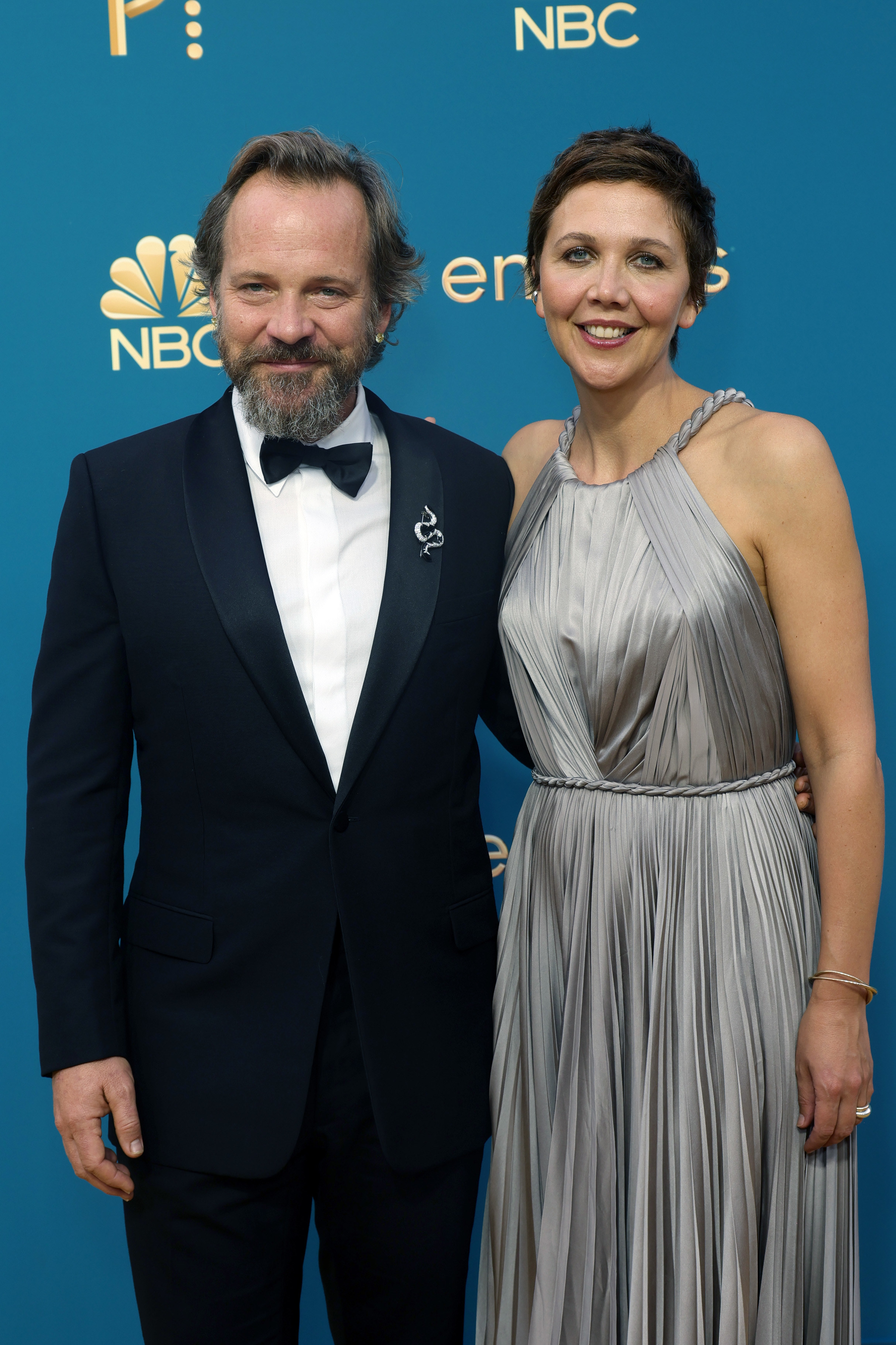 Peter Sarsgaard in a black tux and Maggie Gyllenhaal in a silver gown